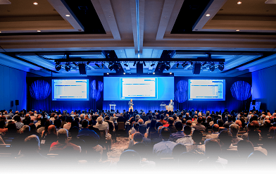 People listening to a speaker on a conference